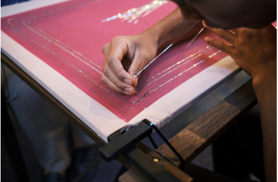 A student in action carrying out the intricate stitching